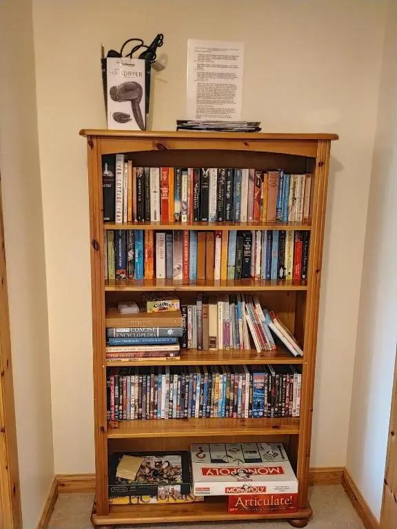 a book shelf filled with books at Peaceful Sea View Home only 5 miles from Inverness in North Kessock