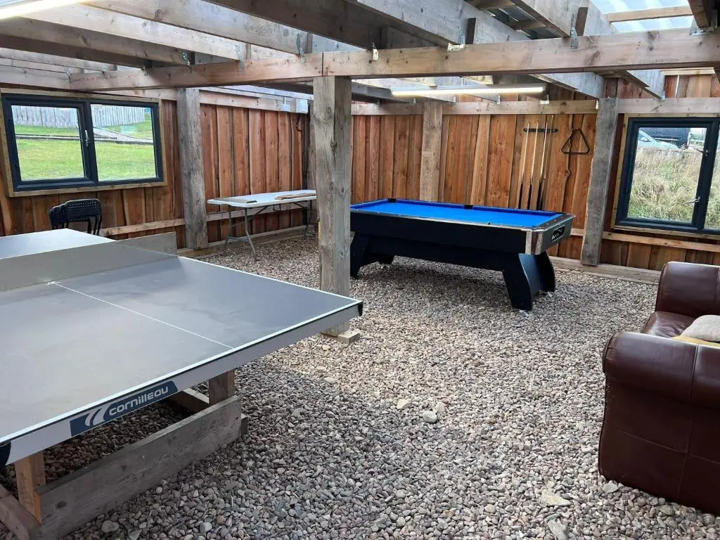 a ping pong room with a ping pong table at Willow Straw Bale Cabin