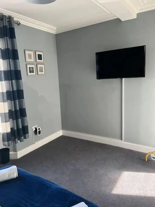a room with a flat screen tv on a wall at GWR Dickson's House, NC500, Wick in Wick