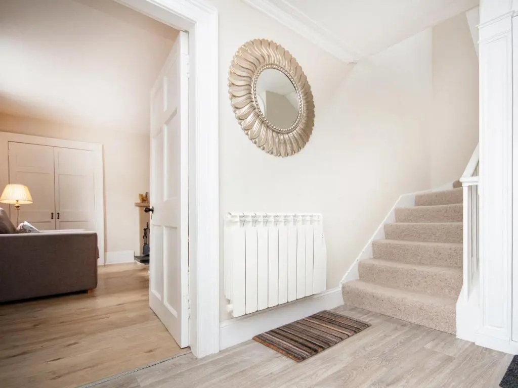 a stairway with a mirror on a wall at Solus Na Madainn in Tain