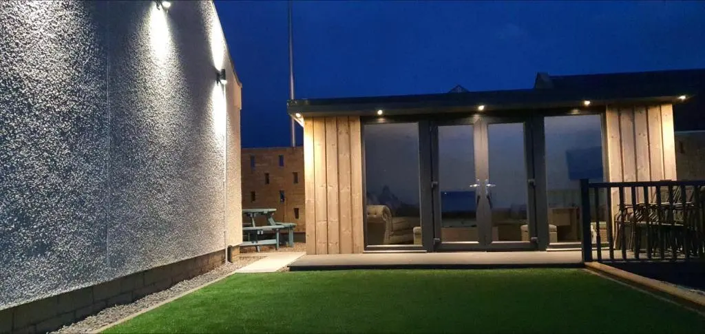 a house with a patio with green grass at Salt View in Cullen