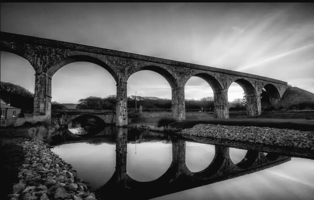 a black and white photo of a bridge over water at Salt View in Cullen