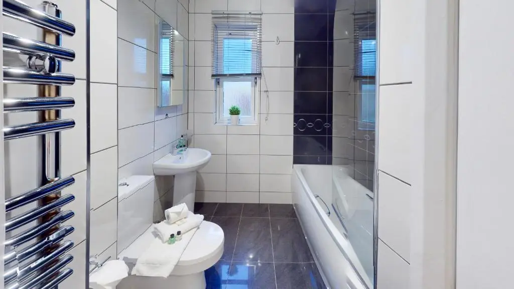 a bathroom with a toilet and a tub and a sink at Pine Marten Cottage - Aviemore in Aviemore