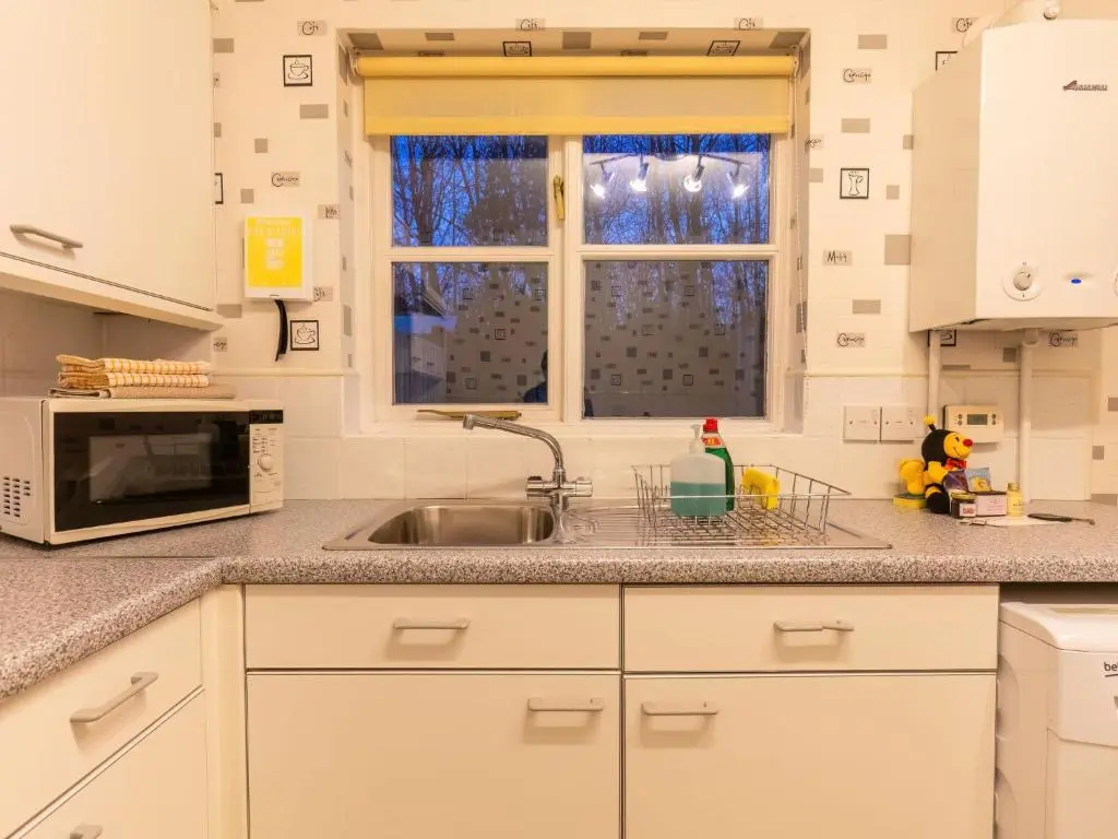 a kitchen with a sink and a microwave at Villa Cedar House by Interhome in Inverness