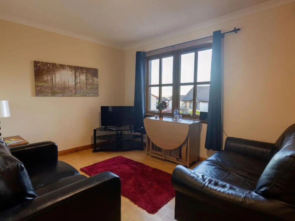 a living room with two leather chairs and a window at Apartment Towerhill Heights by Interhome in Inverness