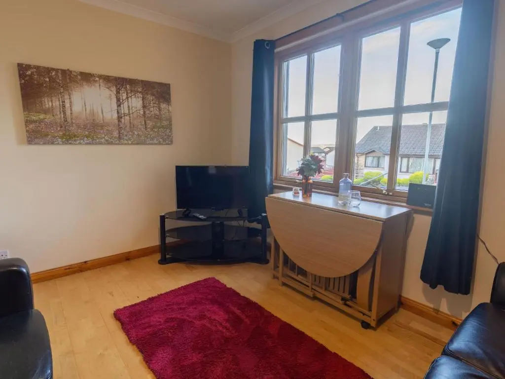 a living room with a desk and a large window at Apartment Towerhill Heights by Interhome in Inverness