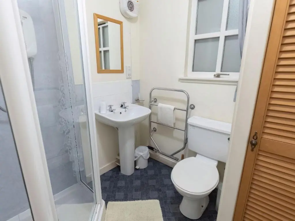 a bathroom with a toilet and a sink and a shower at Holiday Home Old Lodge by Interhome in Inverness