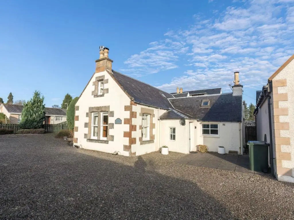 a large white house with a black roof at Holiday Home Old Lodge by Interhome in Inverness