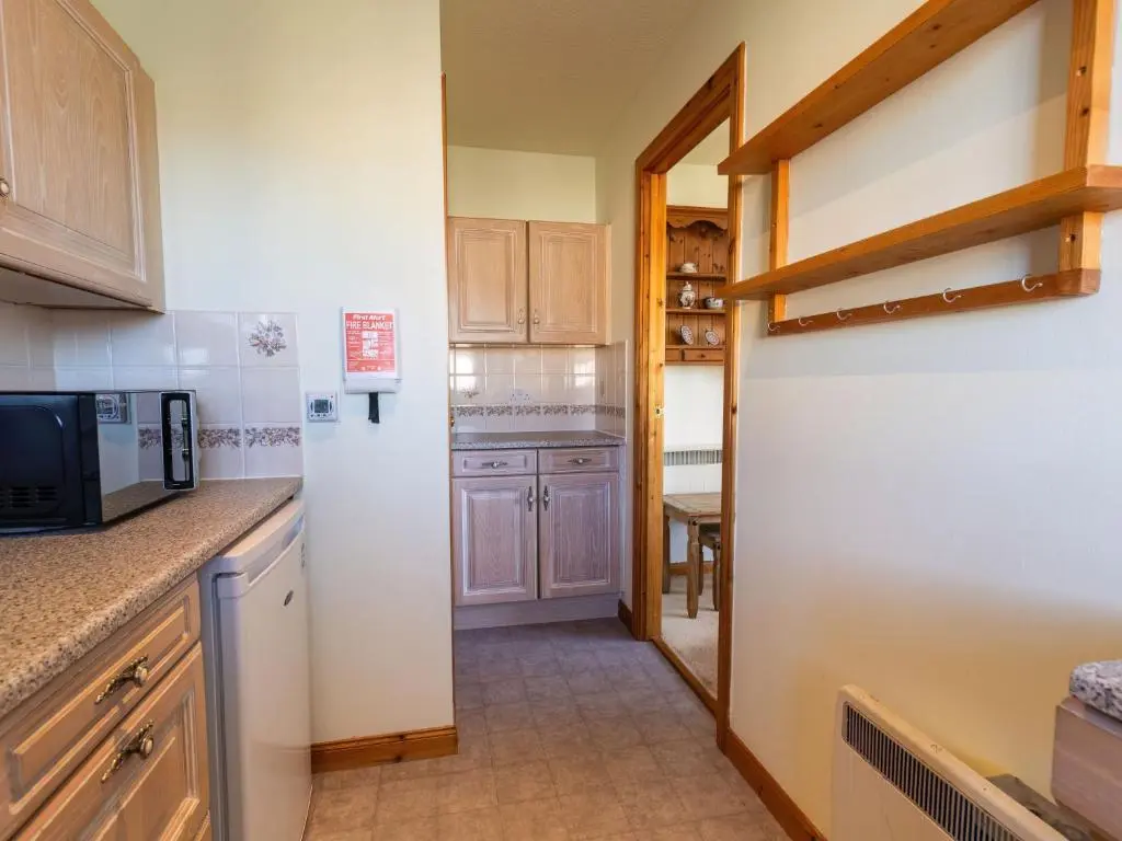 a kitchen with a refrigerator and a microwave at Apartment Millar House by Interhome in Inverness