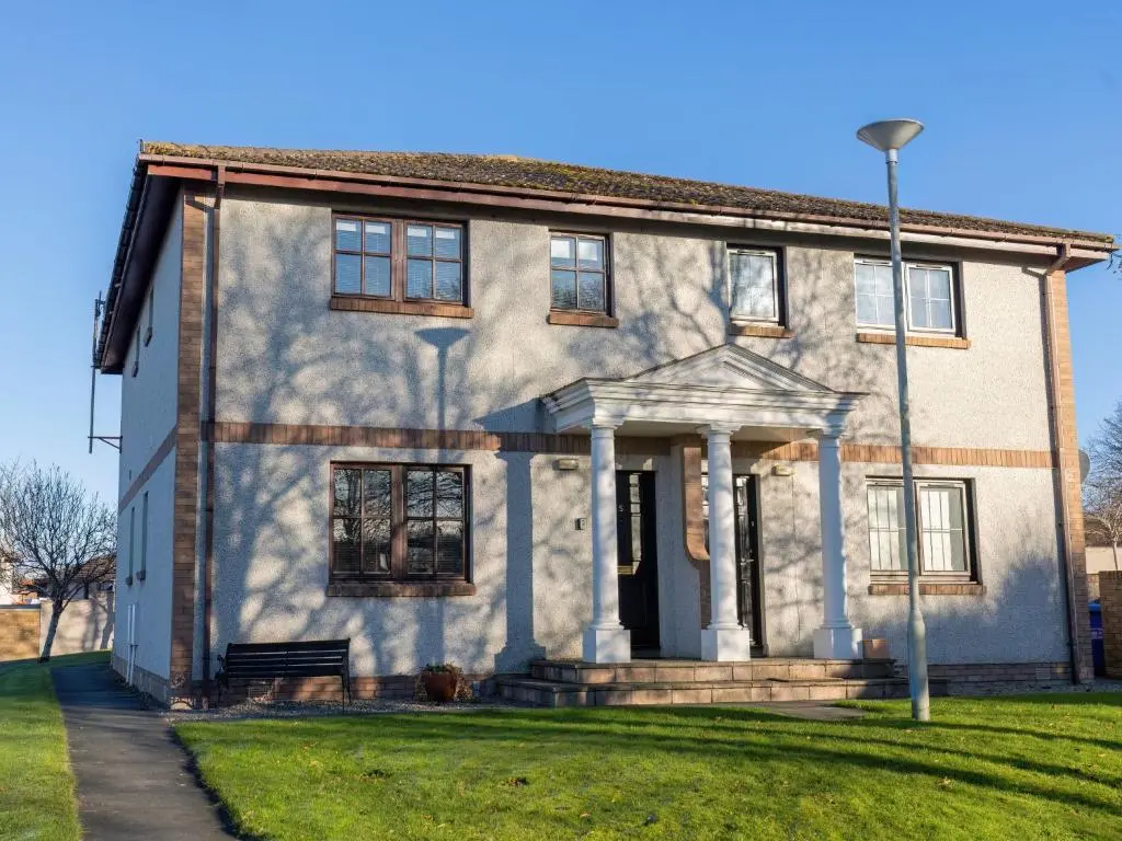 an old house with a porch on a lawn at Apartment Millar House by Interhome in Inverness