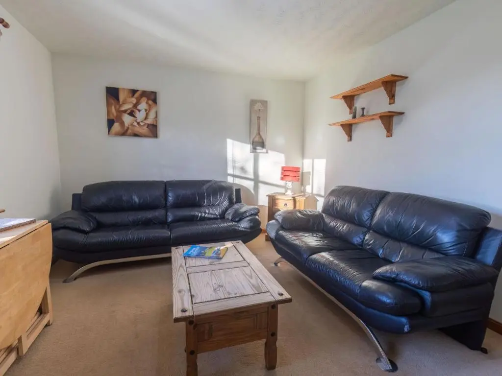 a living room with two leather couches and a coffee table at Apartment Millar House by Interhome in Inverness