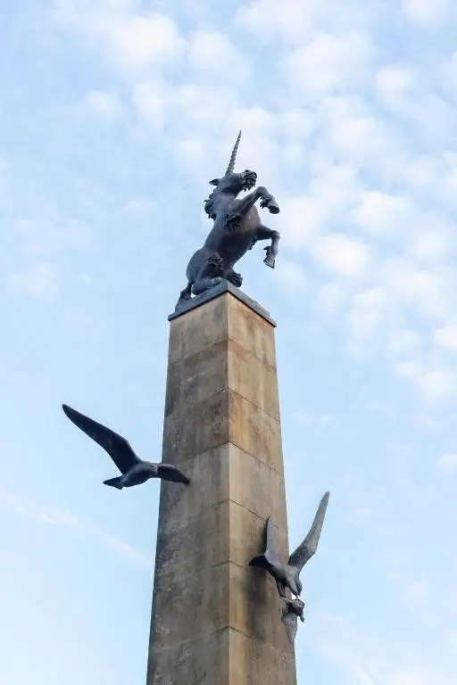 a statue on top of a tower with two birds at Apartment Old Edinburgh Cottage by Interhome in Inverness