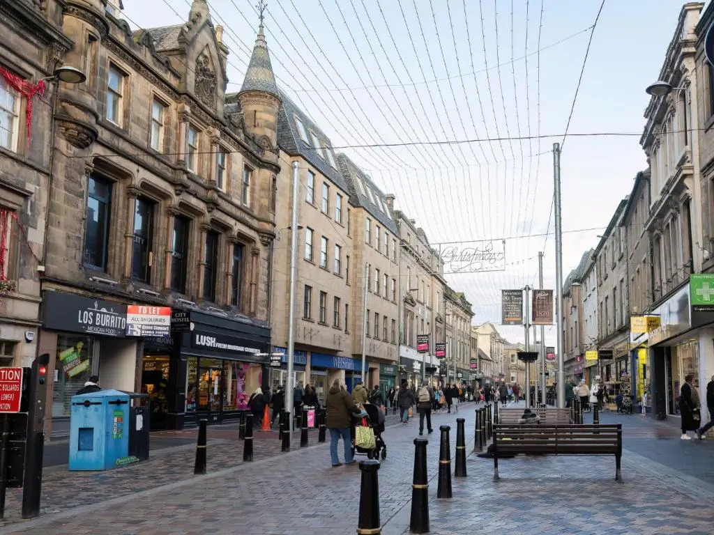 a group of people walking down a city street at Apartment Old Edinburgh Cottage by Interhome in Inverness