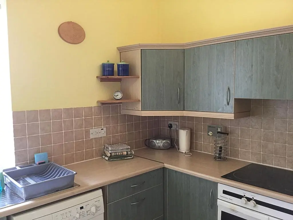 a kitchen with green cabinets and a counter top at Apartment Old Edinburgh Cottage by Interhome in Inverness