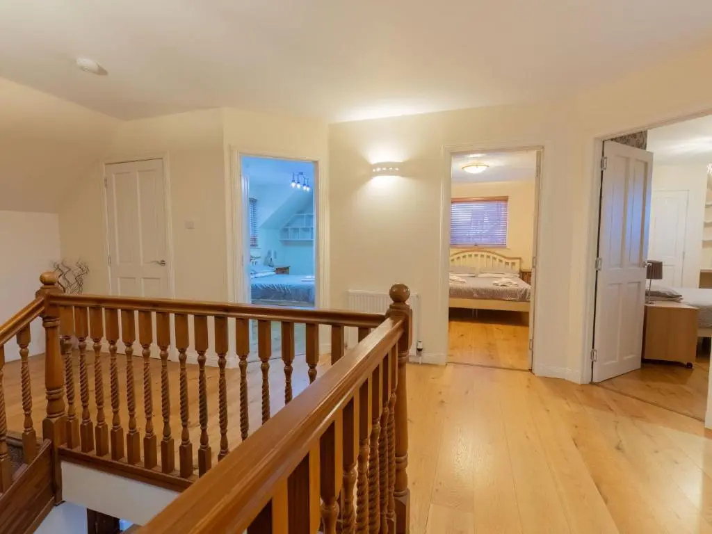 a hallway with a staircase and a bedroom with a bed at Villa Evergreen House by Interhome in Inverness