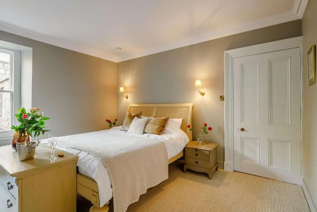 a bedroom with a white bed and a window at Manar House Ground Floor Luxury Apartment in Inverurie