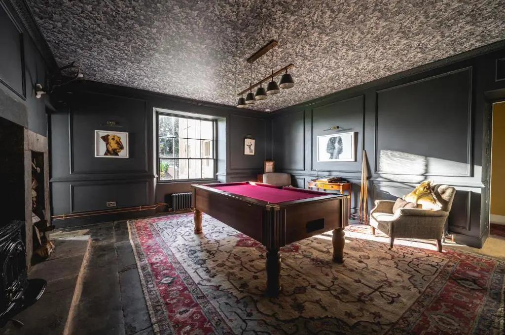 a room with a ping pong table in the middle at Manar House Ground Floor Luxury Apartment in Inverurie