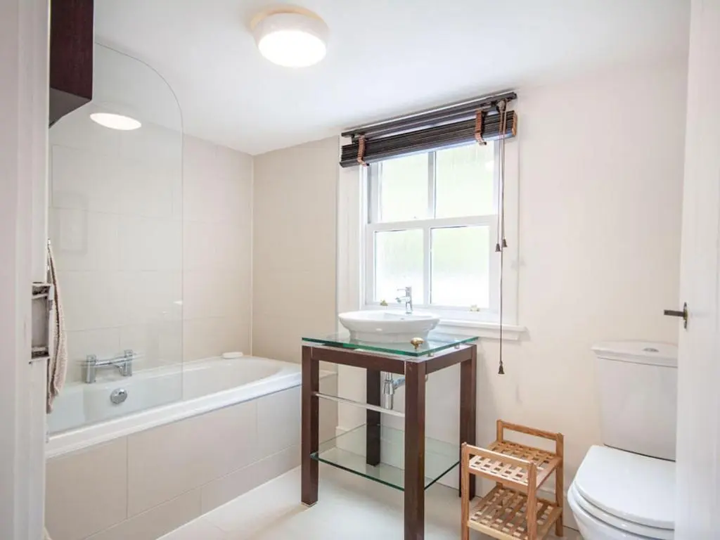 a bathroom with a sink and a tub and a toilet at Braefoot in Fortrose