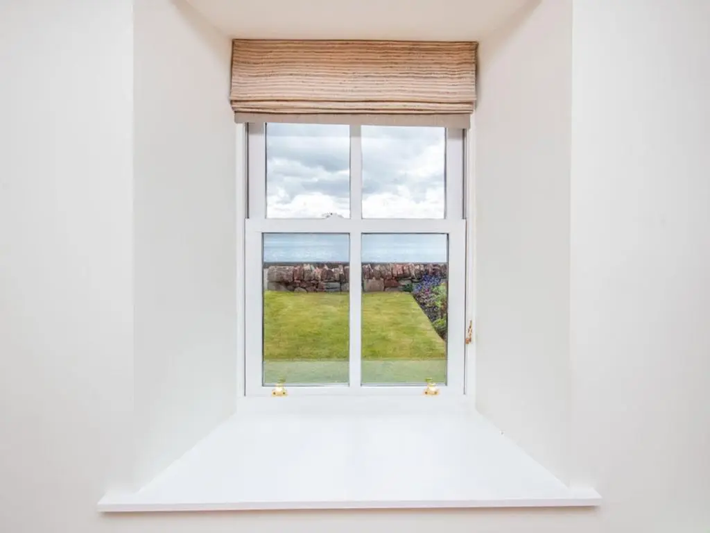 an open window with a view of a yard at Braefoot in Fortrose