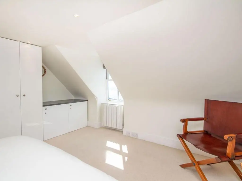 a bedroom with a bed and a wooden chair at Braefoot in Fortrose