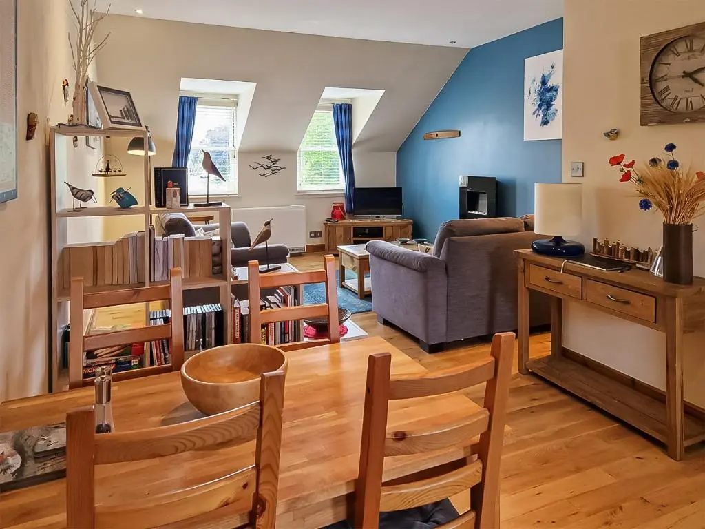 a living room with a couch and a table at Bird's Eye View in Dornoch
