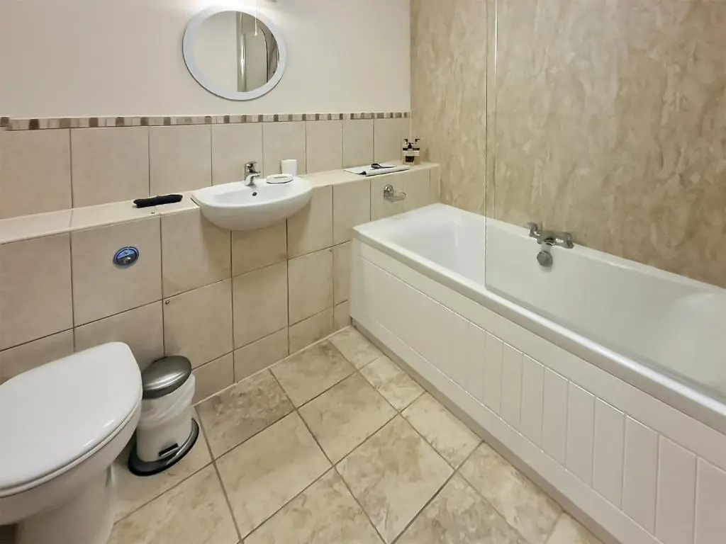 a bathroom with a sink and a tub and a toilet at Bird's Eye View in Dornoch
