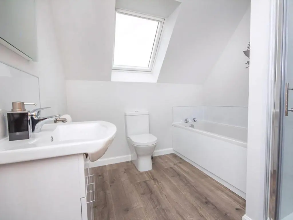 a white bathroom with a sink and a toilet at On The Beach-Uk7465 in Balintore