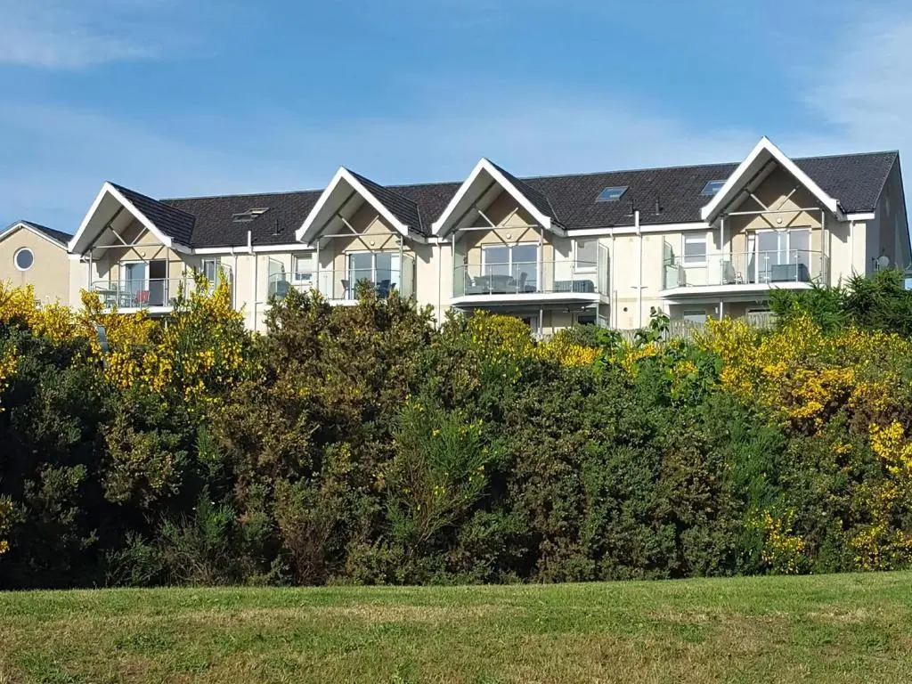 a large house with solar panels on its roof at Fairway Apartment in Nairn