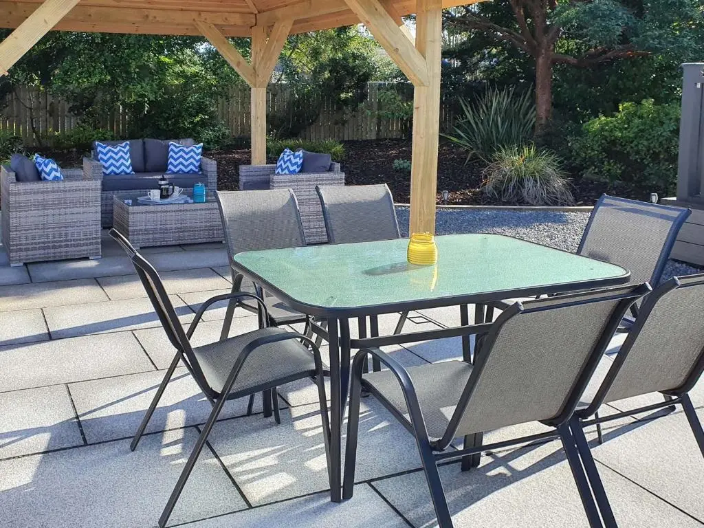 a table and chairs under a gazebo on a patio at Sunnyside Culloden in Inverness