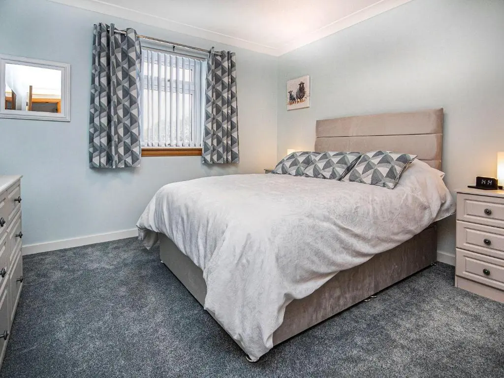 a bedroom with a bed and a window at Terra Verde in Beauly