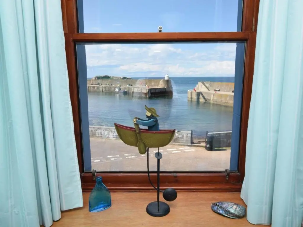 a window with a figurine of a woman in a boat at 2 Bed in Findochty 76557 in Findochty