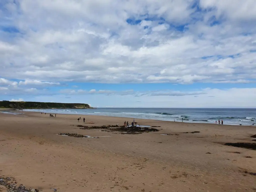 a group of people standing on a beach at 2 Bed in Findochty 76557 in Findochty