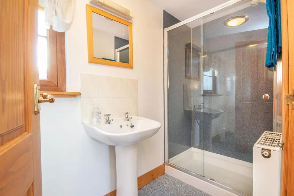 a bathroom with a sink and a shower at 23 Fairfield in Inverness
