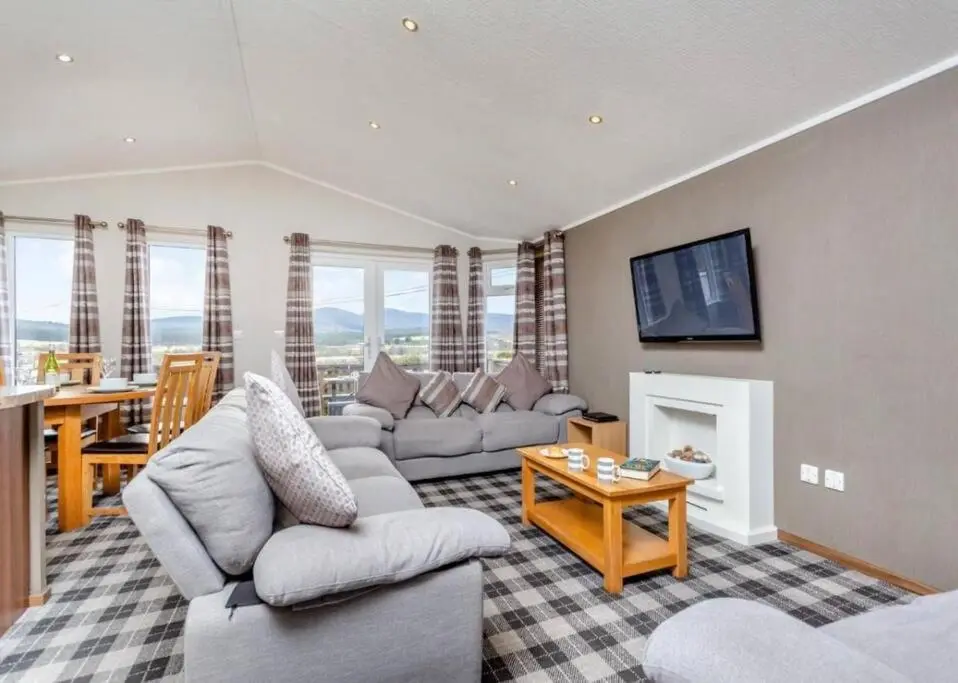 a living room with a couch and a table at Scottish retreat in Banchory