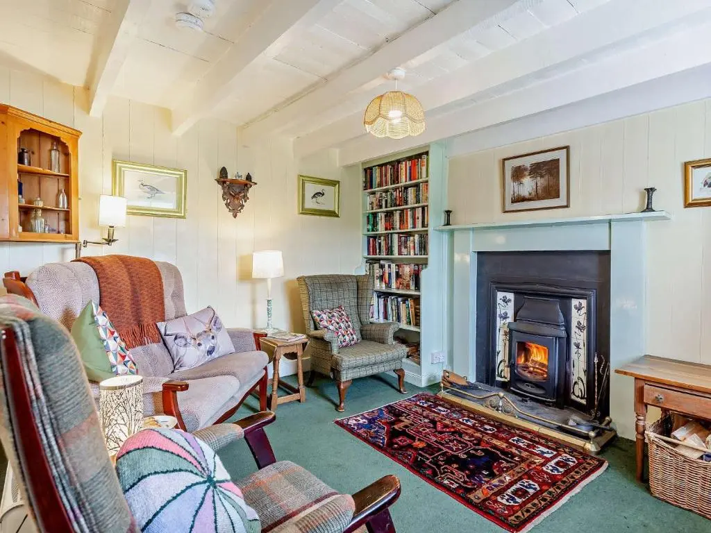 a living room with a fireplace and a fire place at 3 Bed in Kildonan SU192 in Helmsdale