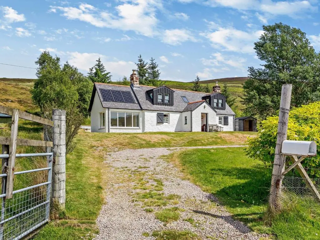a house on a hill with a fence at 3 Bed in Kildonan SU192 in Helmsdale