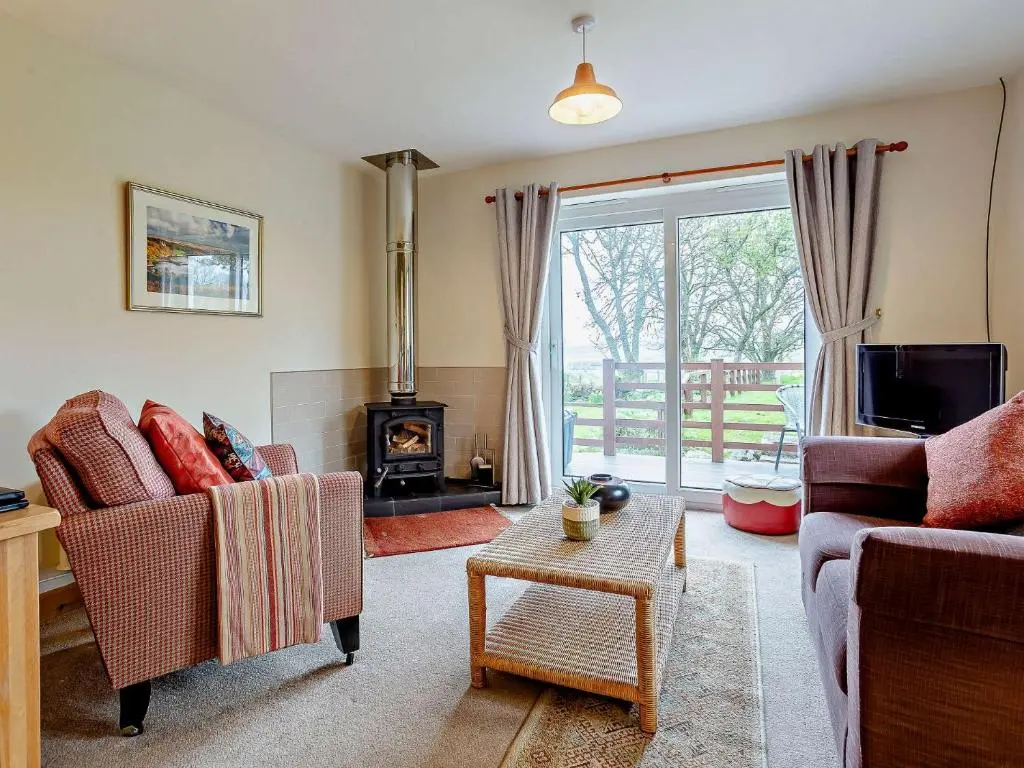 a living room with two chairs and a fireplace at 1 Bed in Beauly 82778 in Beauly