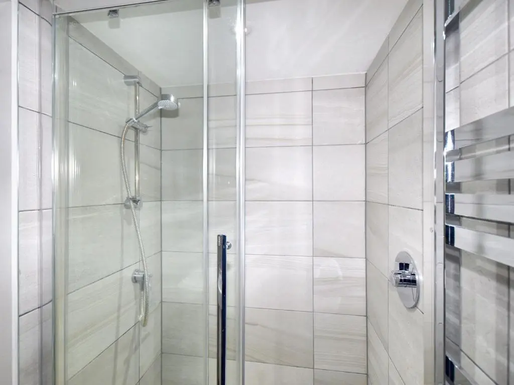 a shower with a glass door in a bathroom at 3 Bed in Dinnet 53150 in Dinnet