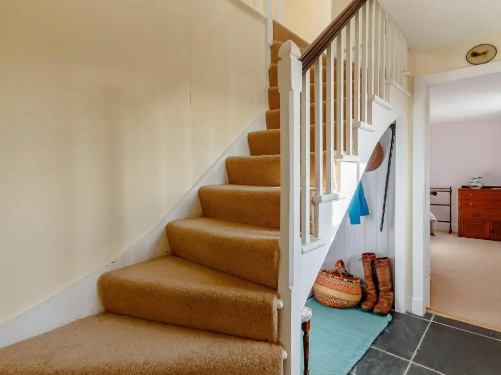 a staircase in a home with brown carpeting and a stair case at 3 Bed in Dinnet 53150 in Dinnet