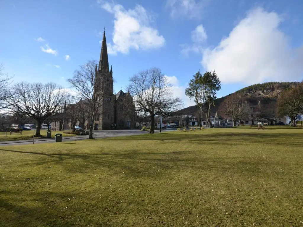 a church with a large field of grass in front of it at 3 Bed in Dinnet 53150 in Dinnet