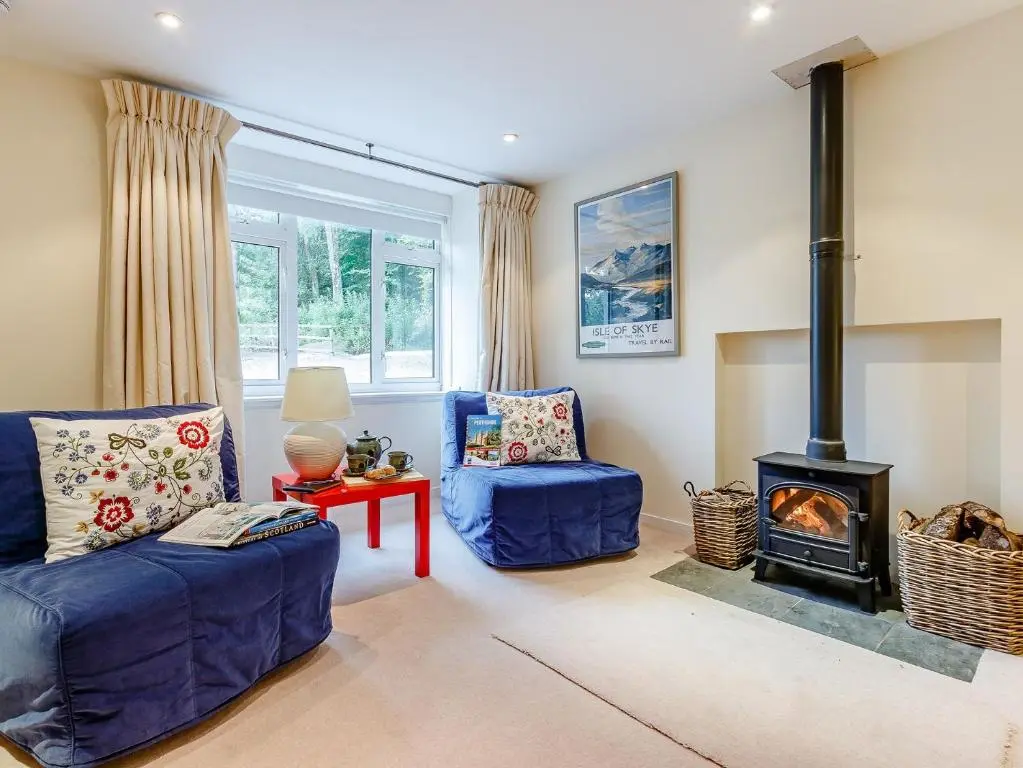 a living room with a blue couch and a stove at 1 Bed in Blacklunans CA361 in Cray