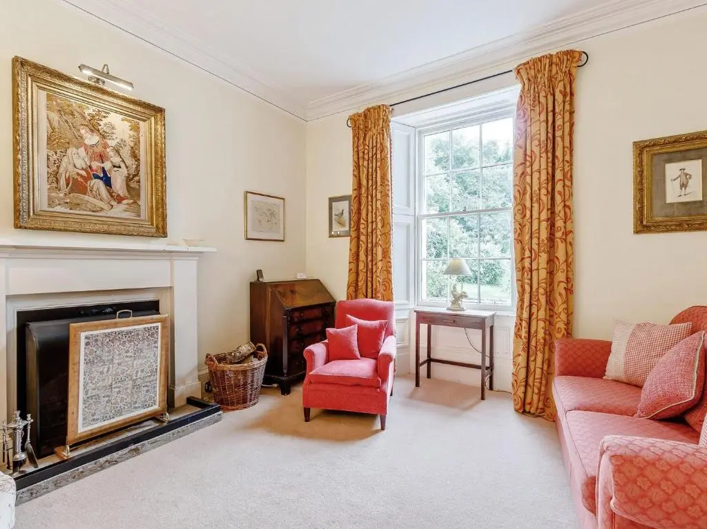 a living room with a fireplace and a red chair at 5 Bed in Blacklunans CA409 in Cray