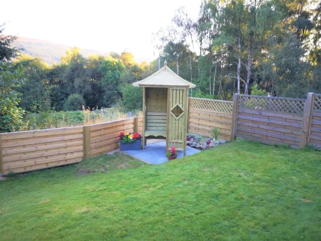 a gazebo in a yard next to a fence at 3 Bed in Drumnadrochit IN633 in Balnain