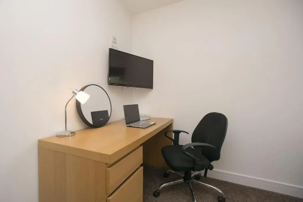 an office with a desk with a chair and a monitor at Elgin, home from home in Elgin