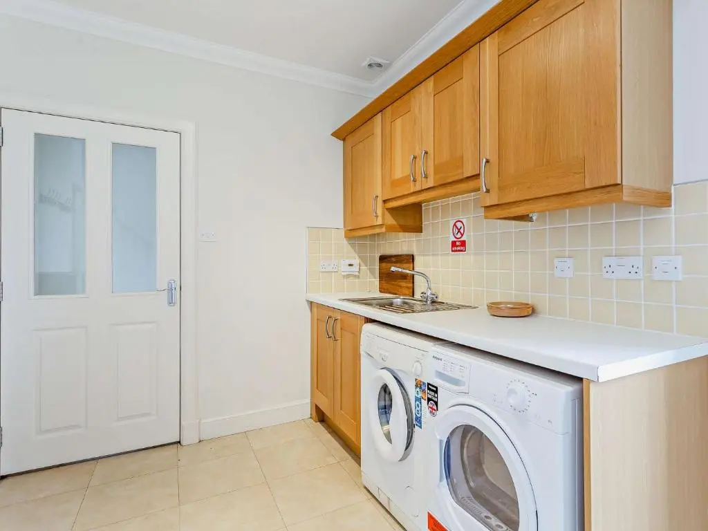a kitchen with a washing machine and a sink at 3 Bed in Conon Bridge CA388 in Cononbridge