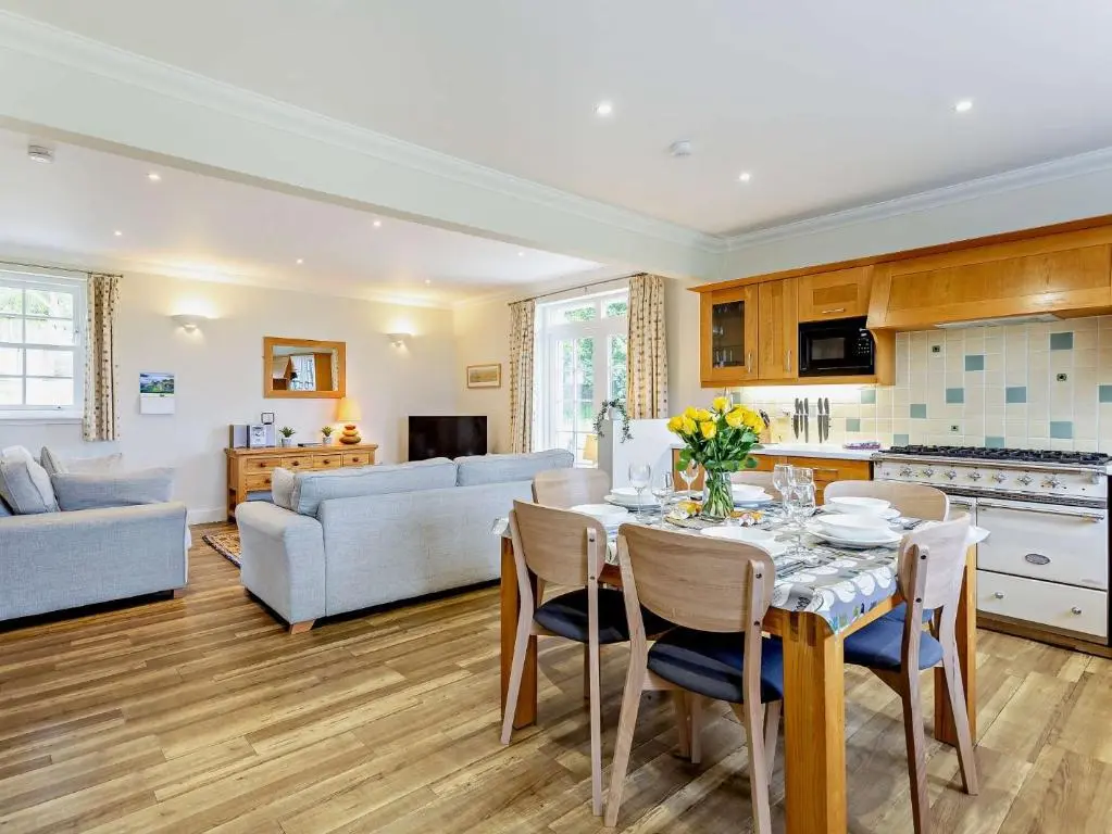 a kitchen and living room with a table and chairs at 3 Bed in Conon Bridge CA388 in Cononbridge