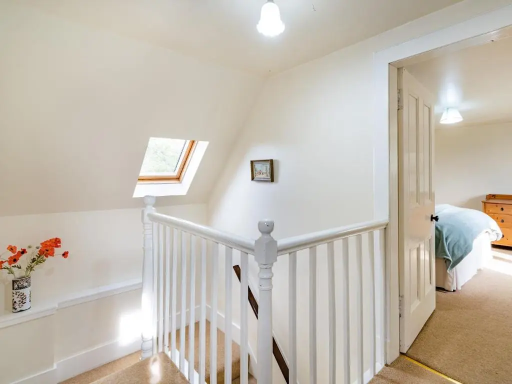 a white staircase in a home with a window at 3 Bed in Carron CA227 in Carron