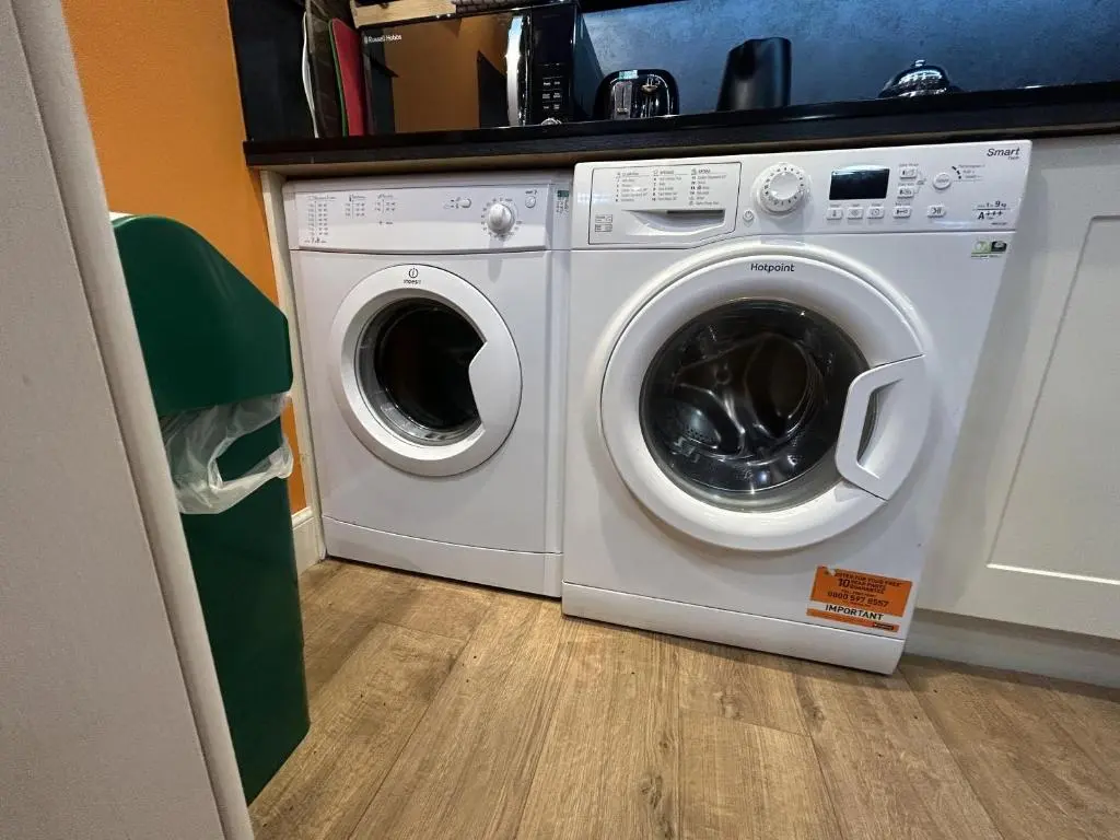a white washer and dryer in a room at The Secret Garden at Old Drynie House - Self Catering in Inverness