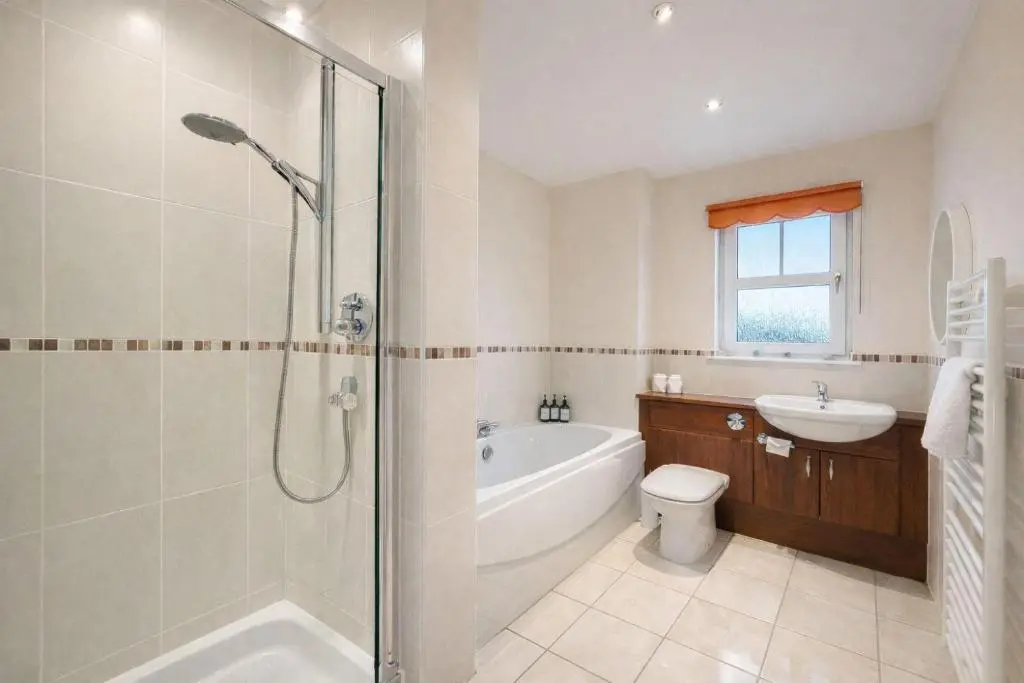 a bathroom with a shower and a toilet and a sink at BraeView House in Inverness
