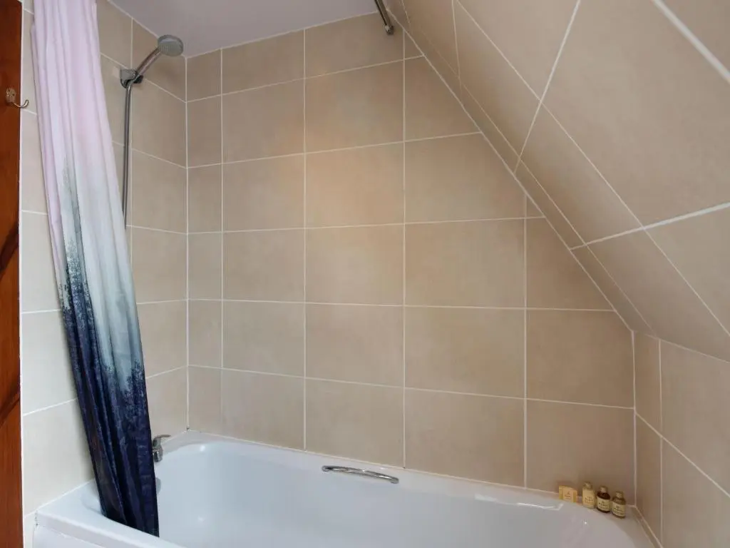 a bathroom with a shower with a white tub at Chalet Caledonia Lodge by Interhome in Spean Bridge